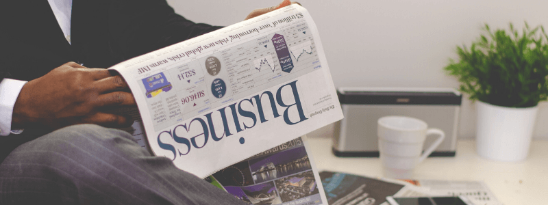 Man reading a business news paper