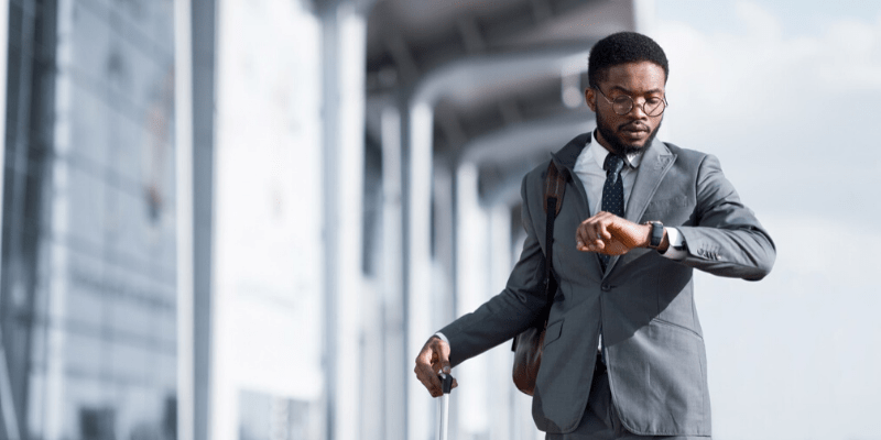 Man dressed smartly looking at watch