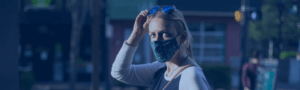 German lady wearing mask with sunglasses raised